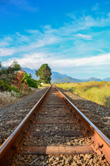 Fototapeta premium Train Tracks leading to the mountains in New Zealand 