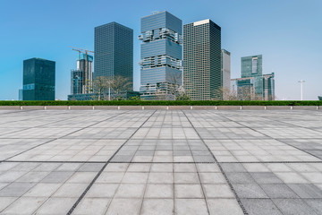 Obraz na płótnie Canvas Urban skyscrapers with empty square floor tiles