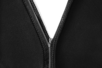 Unbuttoned yellow zipper on a black knitted sweater.