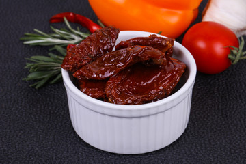 Dried tomatoes in the bowl with olive oil