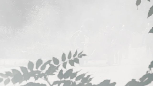Soldiers moving a anti tank gun forward on a battlefield &ndash; heavy smoke