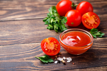 Tomato ketchup sauce on wooden background