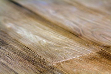 Fototapeta premium Natural light brown wooden parquet floor boards. Sunny soft yellow texture, copy space perspective background.