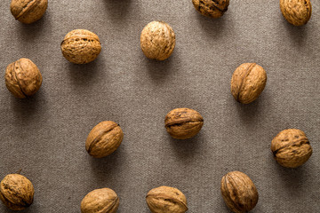 Close-up of walnuts in wooden shell isolated on light copy space background, top view. Healthy tasty organic food concept.
