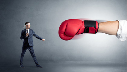 Little man fighting with a giant red boxing glove
