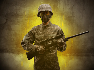 Hazard, menace soldier in a ruined crumbly building with arms on his hand
