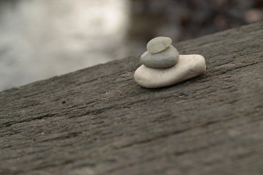 Pebbles on wooden bridge by waterside