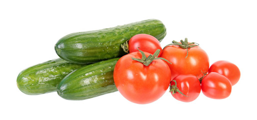 Fresh green cucumbers and red tomatoes isolated on white background. Ingredients for vegetable salad