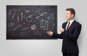 Handsome young teacher with laser pointer teaching 
