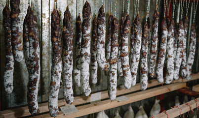 Traditional cured french sausages in the store at Franche Comte smoke house