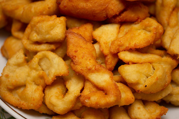 Close - up of A large plate of delicious and fragrant donuts. The recipe is very simple, included:...