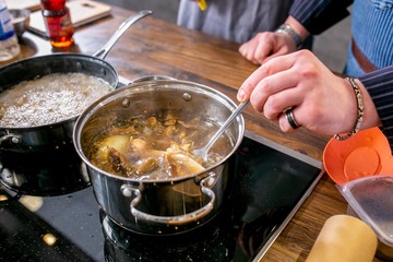 Chef mixes mushrooms in a pan. Master class in the kitchen. The process of cooking. Step by step. Tutorial. Close-up