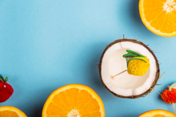 among the juicy oranges on a blue background. Summer Food Concept. Top view, flat lay, copy space