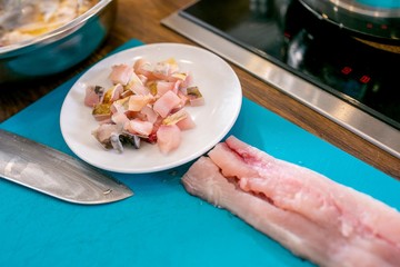 Pieces of raw fish on a plate. Master class in the kitchen. The process of cooking. Step by step. Tutorial. Close-up