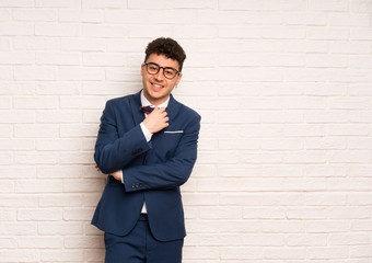 Man in suit and bow tie with glasses and smiling