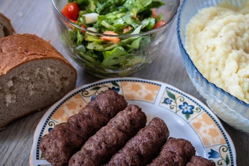 Barbeque Kebab, traditional middle eastern and mediterranean eat from minced meat on the grill with salad