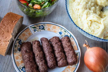 Barbeque Kebab, traditional middle eastern and mediterranean eat from minced meat on the grill with salad