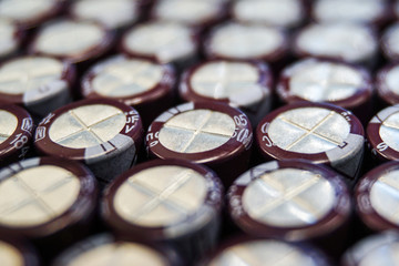 Close-up macro of close aligned electrolytic capacitors communications hardware electronics components packed for mass production