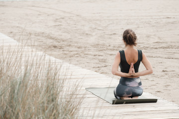 Fototapeta premium a female practicing yoga and meditation