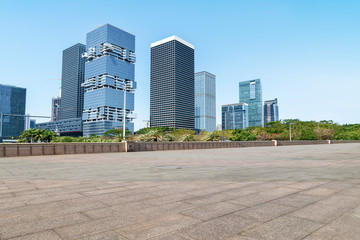 Fototapeta na wymiar Urban skyscrapers with empty square floor tiles