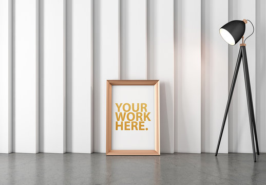 Gold Vertical Frame Leaning on Wall Next to Lamp Mockup