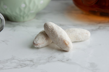 Fototapeta na wymiar Tea with homemade cookies in powdered sugar, close-up