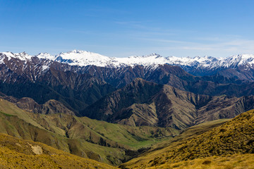 idillic landscape with mountain range, brown hills during sunny day, perfect hiking area