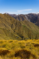 idillic landscape with mountain range, brown hills during sunny day, perfect hiking area, footpath leading into mountains 
