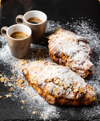 Croissants with almonds on the black background