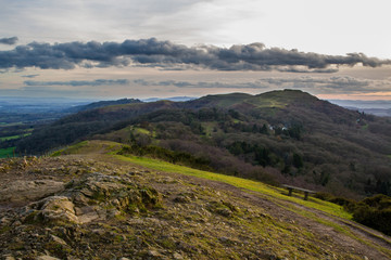 Fototapeta na wymiar Rocky hilltop with southern part of the malvern hills including herefordshire beacon in the background