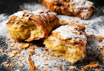 Croissants with almonds on the black background