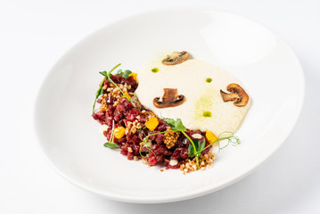 plate with delicious tartare and mushroom puree. Isolated on the white background