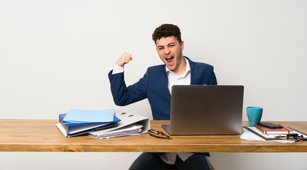 Business man in a office doing strong gesture