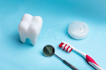 Artificial Tooth And Dental Equipment On Blue Background