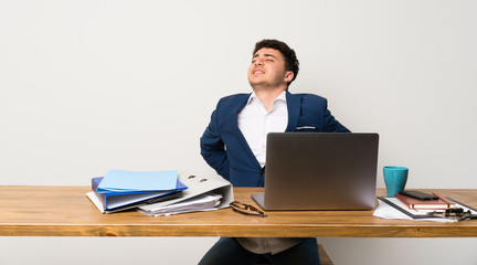 Business man in a office suffering from backache for having made an effort