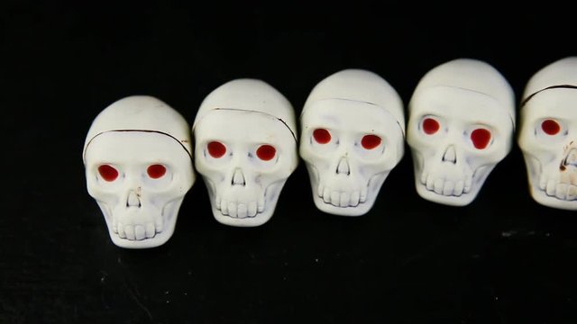 panorama of many white chocolate candies in skeleton skull shape