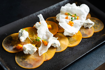 persimmon  carpaccio with  goat cheese and farm cottage cheese