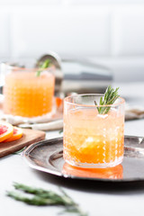 Cocktail with grapefruit juice and rosemary