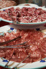 Food tray with sliced ham meat and cheese top view, close-up