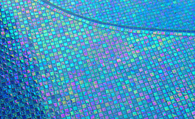 Mixed blue colored square tile mosaic background underwater in a swimming pool