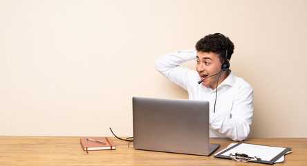 Telemarketer man surprised and pointing finger to the side