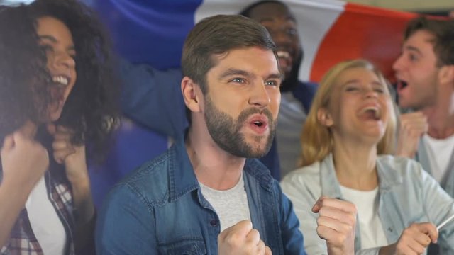 Happy people with French flag celebrating goal of national football team, league