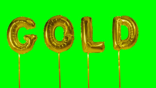 Word gold from helium balloon letters floating on green screen