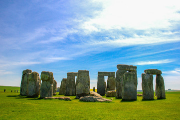 Naklejka premium Travel England, United Kingdom. Popular tourist destination in Europe. The ancient monument, famous, mysterious Stonehenge attraction. Sunny day, blue sky. Travel/outdoor background.