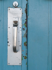 Commercial door handle on blue door