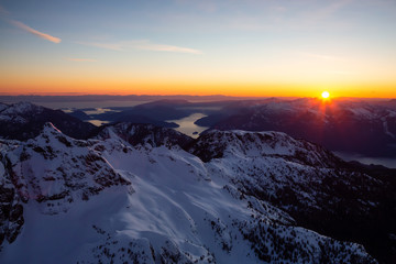 Aerial view of Canadian Mountain Landscape during a vibrant sunset. Taken near Squamish, North of Vancouver, British Columbia, Canada.
