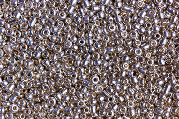 Background texture silver beads close-up.