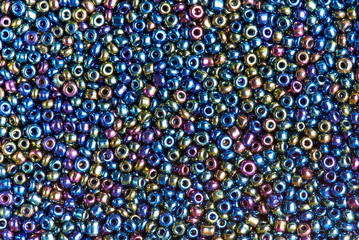 Background texture of multicolored iridescent beads closeup.