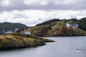 Fototapeta na wymiar Scenic view of a small town on the Atlantic Ocean Coast during a cloudy evening. Taken in Salt Harbour, Newfoundland and Labrador, Canada.