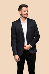 Handsome business man smiling over ocher background